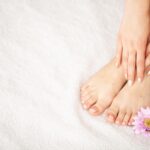 Hand and Nail Care. Beautiful Women's Feet with Pedicure in Beauty Salon.